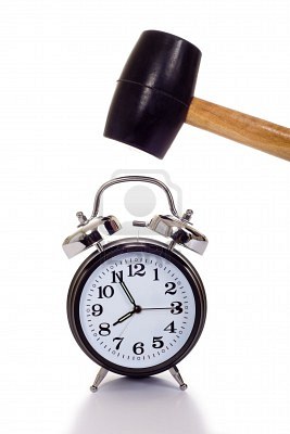 3874834-a-hand-holding-a-black-mallet-or-hammer-about-to-crush-an-old-fashioned-alarm-clock-on-a-white-backg.jpeg